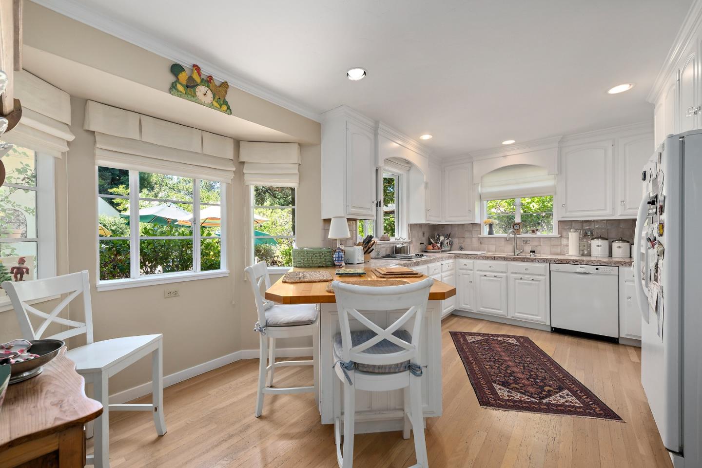 72 Winchester Drive Atherton, CA 94027 - Photo 10 of 50 a kitchen with a table chairs sink and cabinets