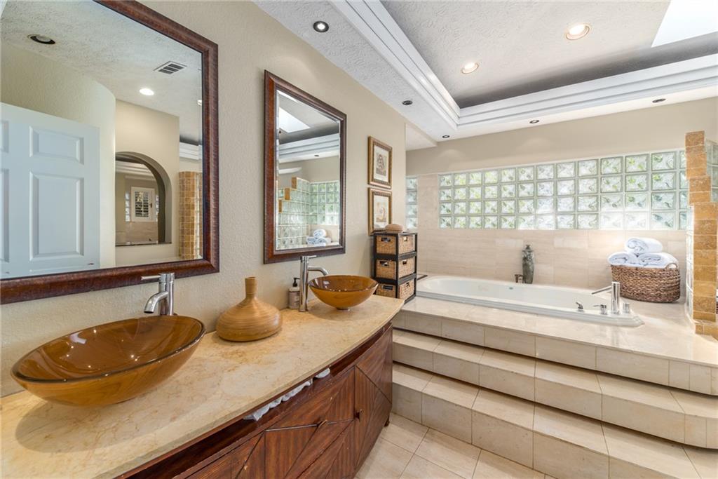 137 South River Road Stuart, FL 34996 - Photo 23 of 55 a bathroom with double vanity sinks double vanity and a bathtub