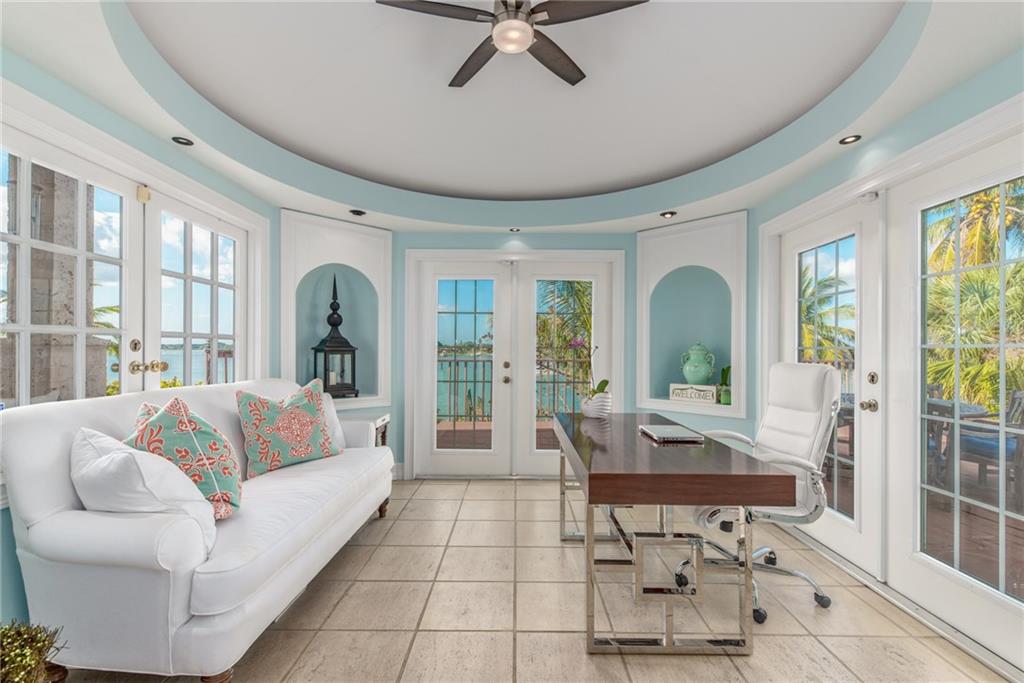 137 South River Road Stuart, FL 34996 - Photo 25 of 55 a living room with furniture and floor to ceiling windows
