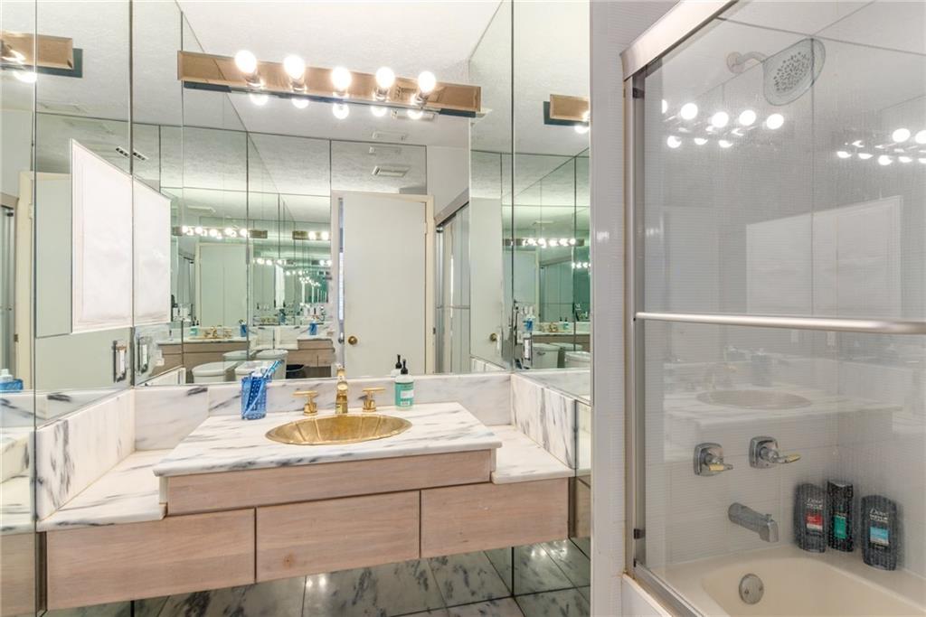137 South River Road Stuart, FL 34996 - Photo 27 of 55 a bathroom with a sink double vanity and a shower