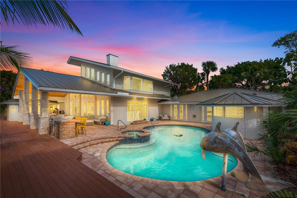 137 South River Road Stuart, FL 34996 - Photo 3 of 55 a swimming pool with outdoor seating yard and barbeque oven