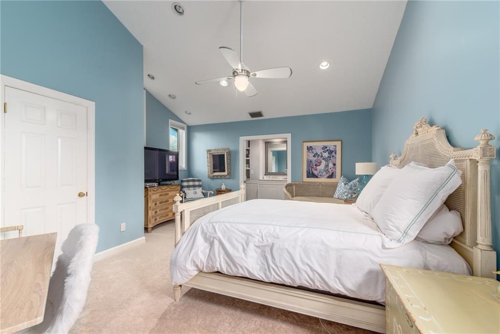 137 South River Road Stuart, FL 34996 - Photo 32 of 55 a bedroom with a large bed and a tv