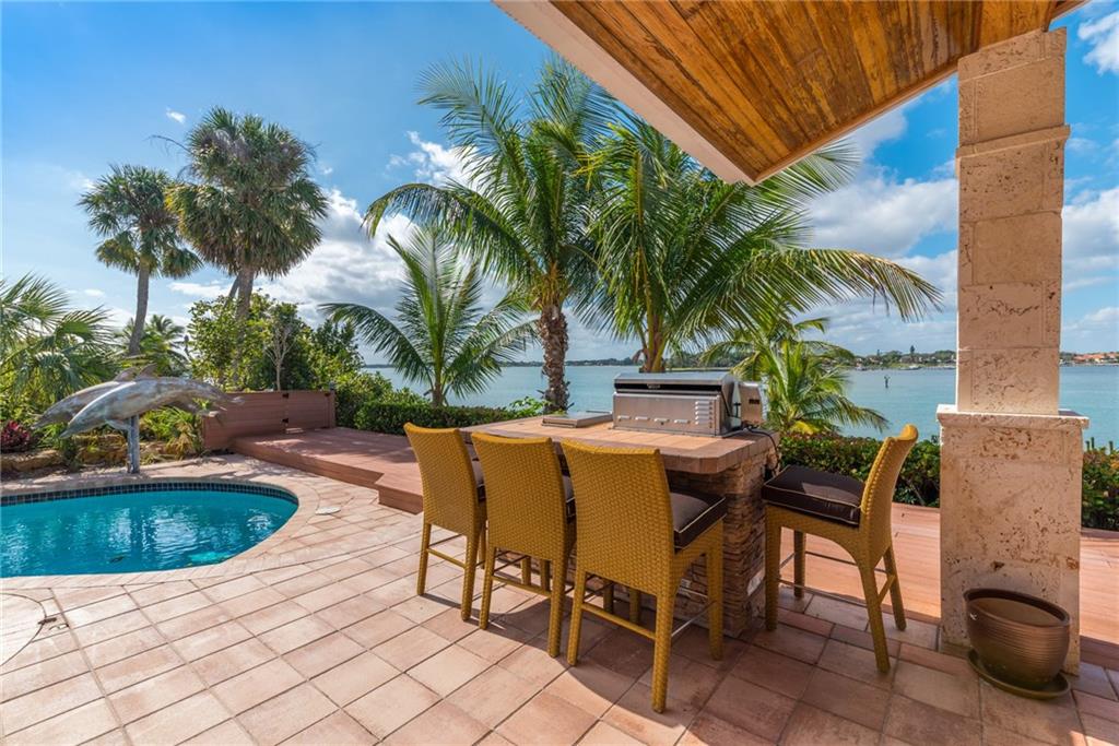 137 South River Road Stuart, FL 34996 - Photo 43 of 55 a view of a swimming pool with chairs