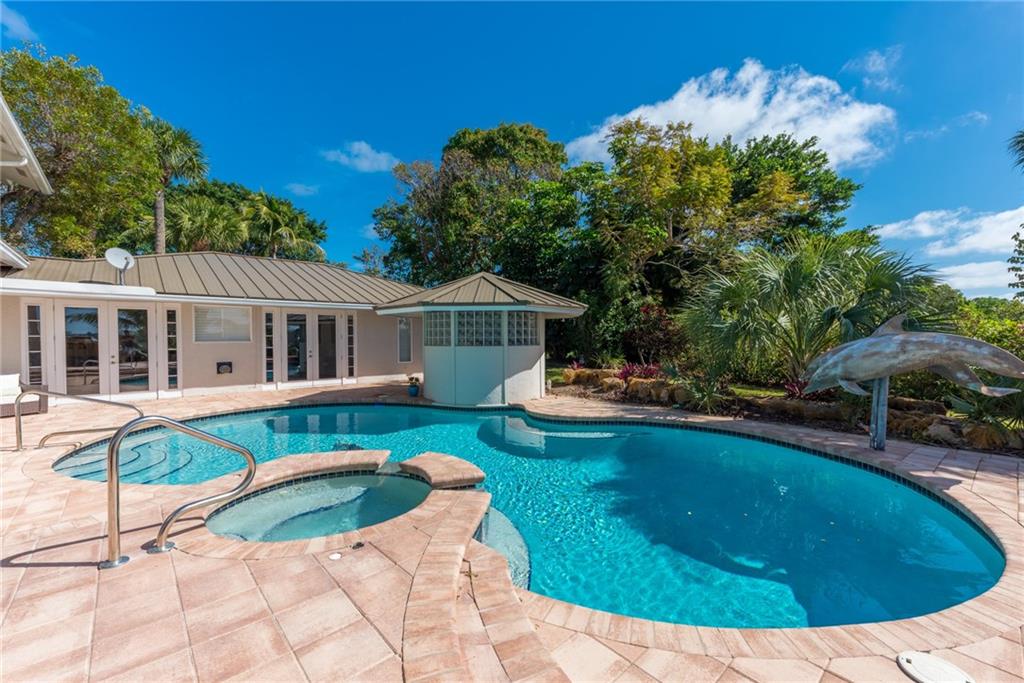 137 South River Road Stuart, FL 34996 - Photo 44 of 55 a view of a house with swimming pool and a yard