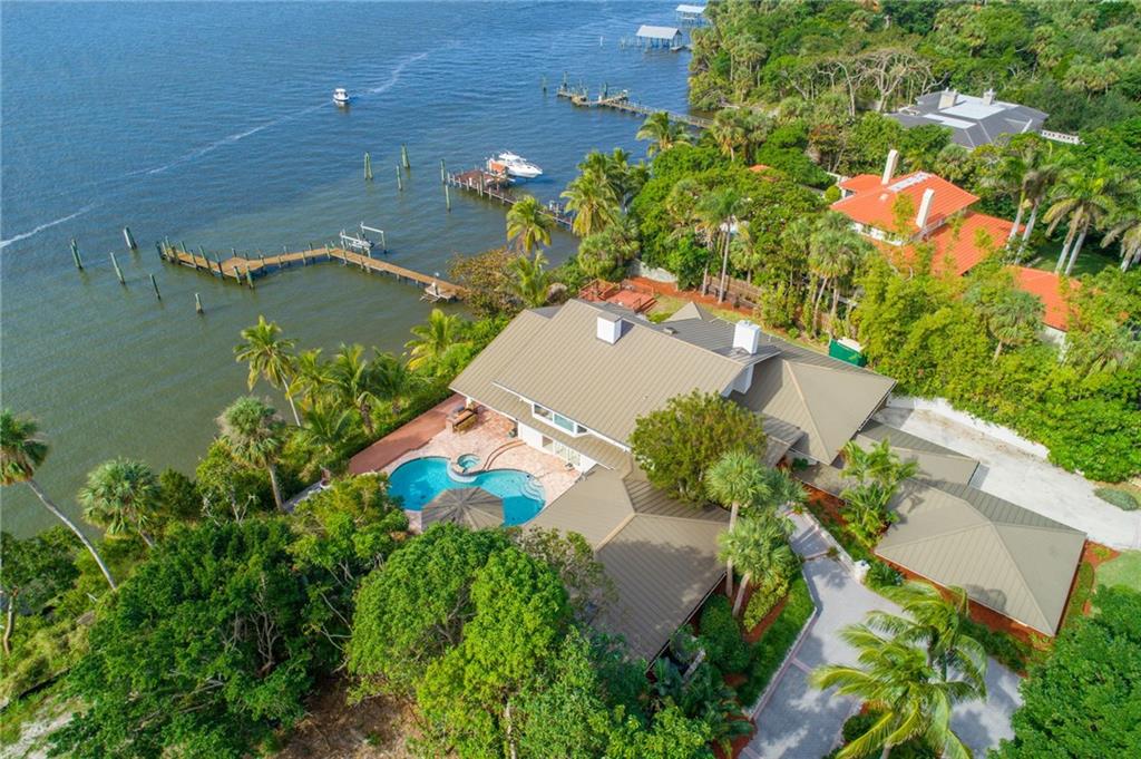 137 South River Road Stuart, FL 34996 - Photo 52 of 55 an aerial view of a house with a yard and lake view