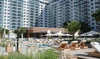 a view of a patio with furniture and a garden