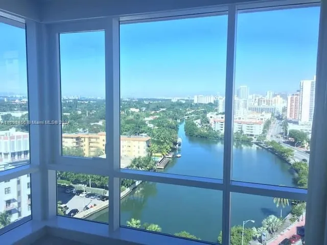 a bed sitting in a bedroom with a lamp