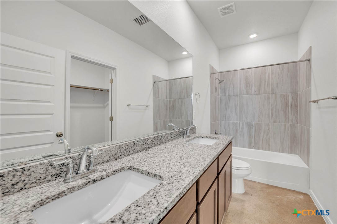 3901 Sugar Hackberry Trail Killeen, TX 76542 - Photo 10 of 16 a bathroom with a granite countertop sink and a mirror