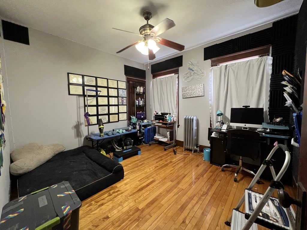 39 Woodford Street, Unit 2 Worcester, MA 01604 - Photo 16 of 20 a bed room with a bed and a television