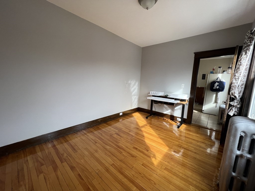 39 Woodford Street, Unit 2 Worcester, MA 01604 - Photo 17 of 20 a view of a room with wooden floor and furniture