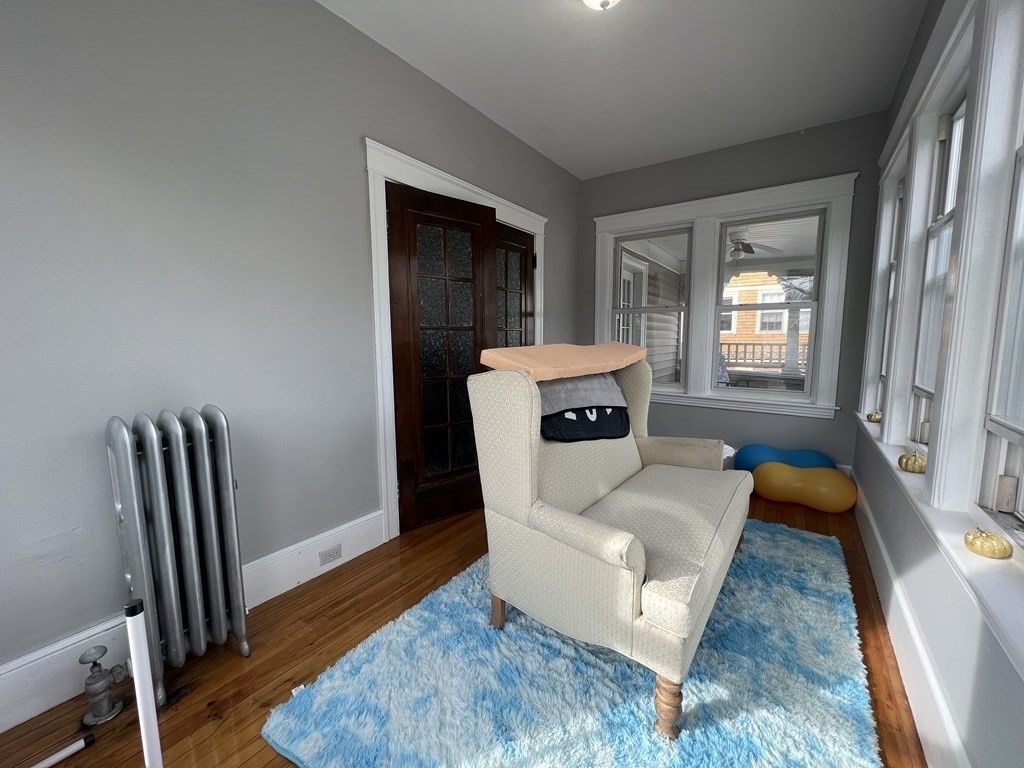 39 Woodford Street, Unit 2 Worcester, MA 01604 - Photo 20 of 20 a living room with furniture and a wooden floor