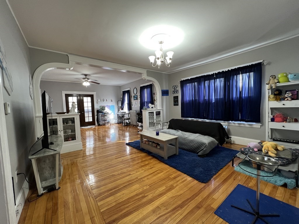 39 Woodford Street, Unit 2 Worcester, MA 01604 - Photo 5 of 20 a living room with furniture and a chandelier
