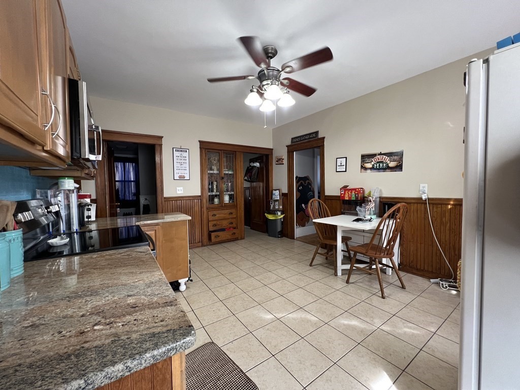 39 Woodford Street, Unit 2 Worcester, MA 01604 - Photo 8 of 20 a living room with furniture a dining table and a refrigerator