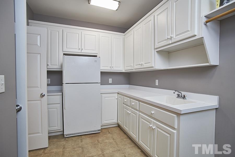 243 Rassie Crabtree Road Rougemont, NC 27572 - Photo 17 of 30 a utility room with cabinets washer and dryer