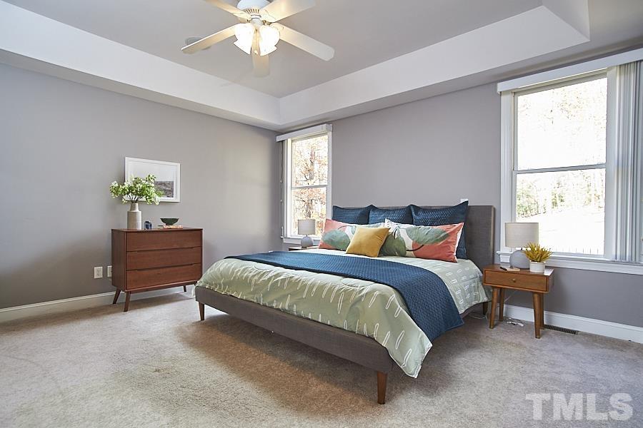 243 Rassie Crabtree Road Rougemont, NC 27572 - Photo 18 of 30 a spacious bedroom with a bed and a chandelier
