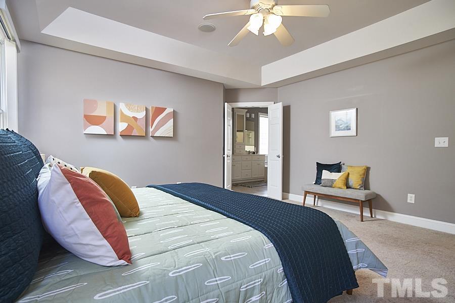 243 Rassie Crabtree Road Rougemont, NC 27572 - Photo 19 of 30 a bedroom with a bed and a chandelier