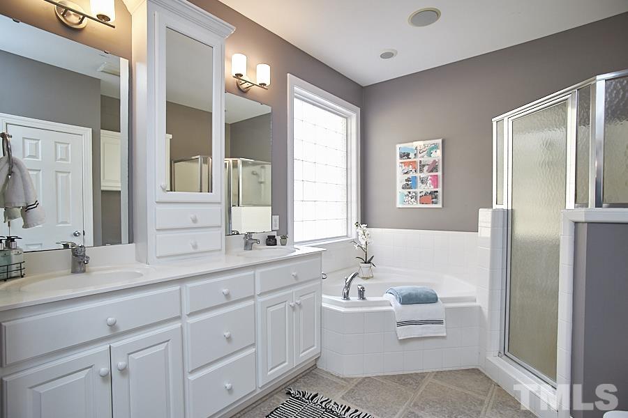 243 Rassie Crabtree Road Rougemont, NC 27572 - Photo 20 of 30 a bathroom with a granite countertop sink mirror and bathtub