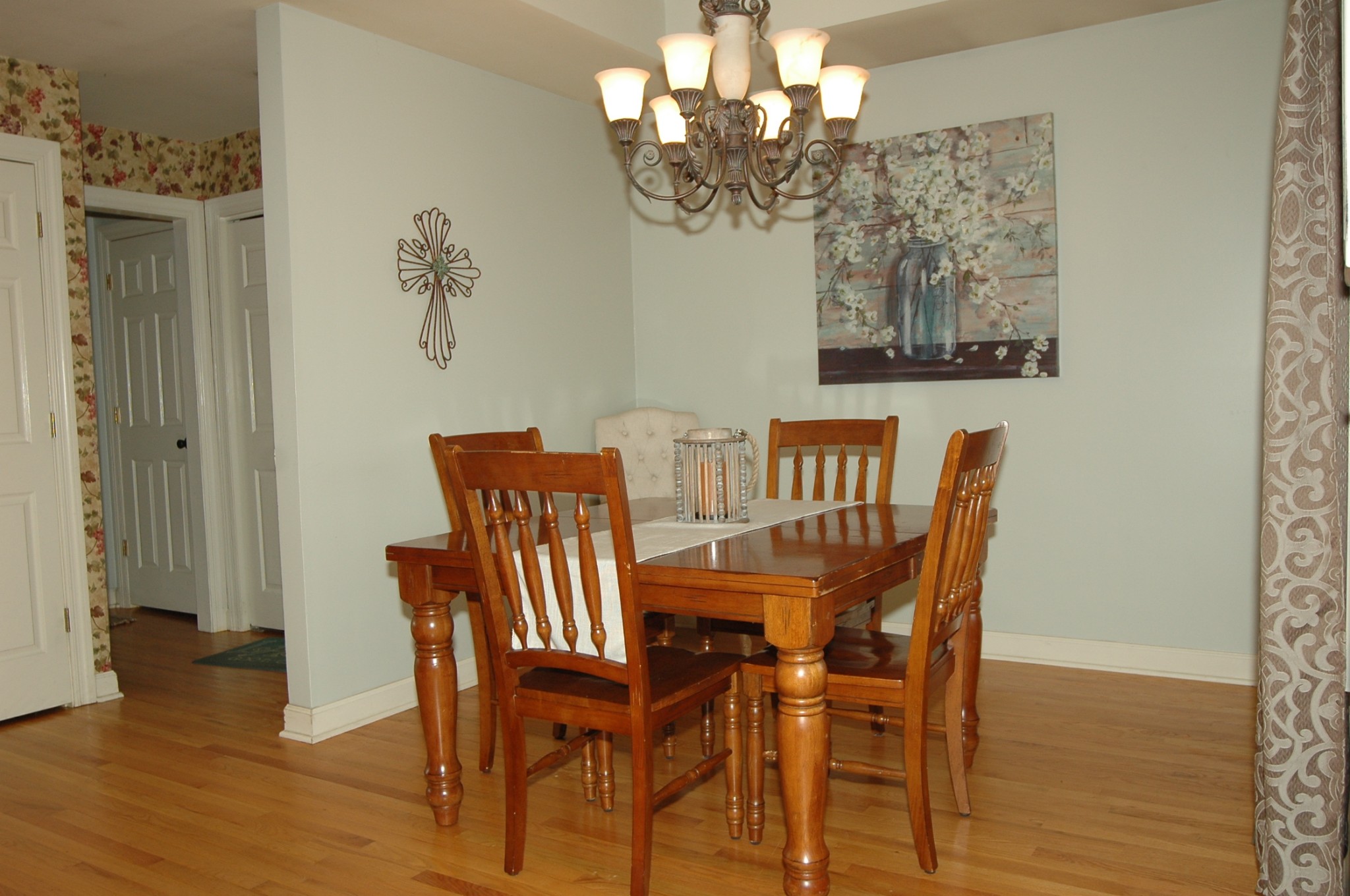 4607 Washington Road Greenbrier, TN 37073 - Photo 18 of 40 a view of a dining room with furniture wooden floor and a chandelier