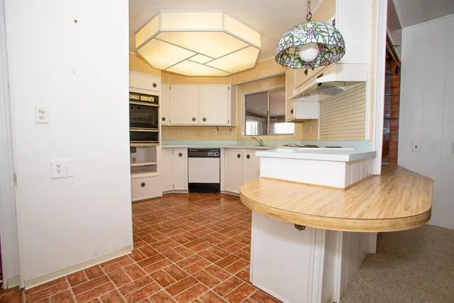 a kitchen with a sink appliances and cabinets