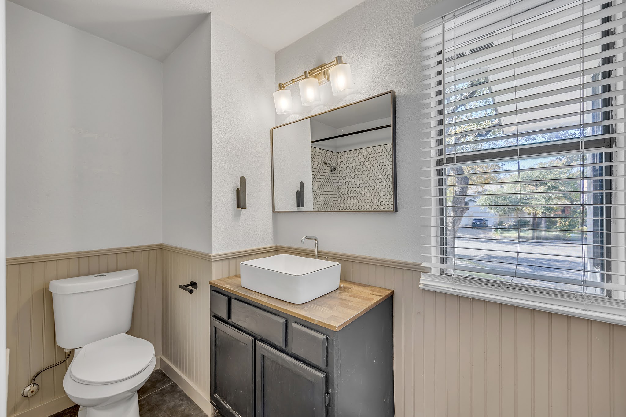 8102 Tuscarora Trail, Unit A Austin, TX 78729 - Photo 24 of 35 a bathroom with a toilet sink and mirror