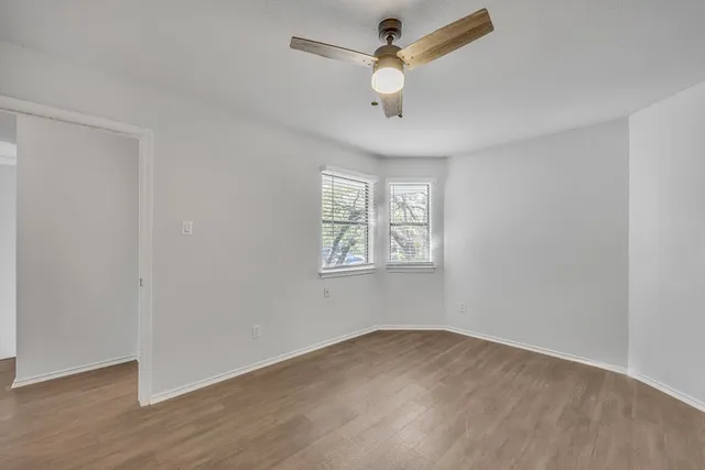 wooden floor in an empty room with a window