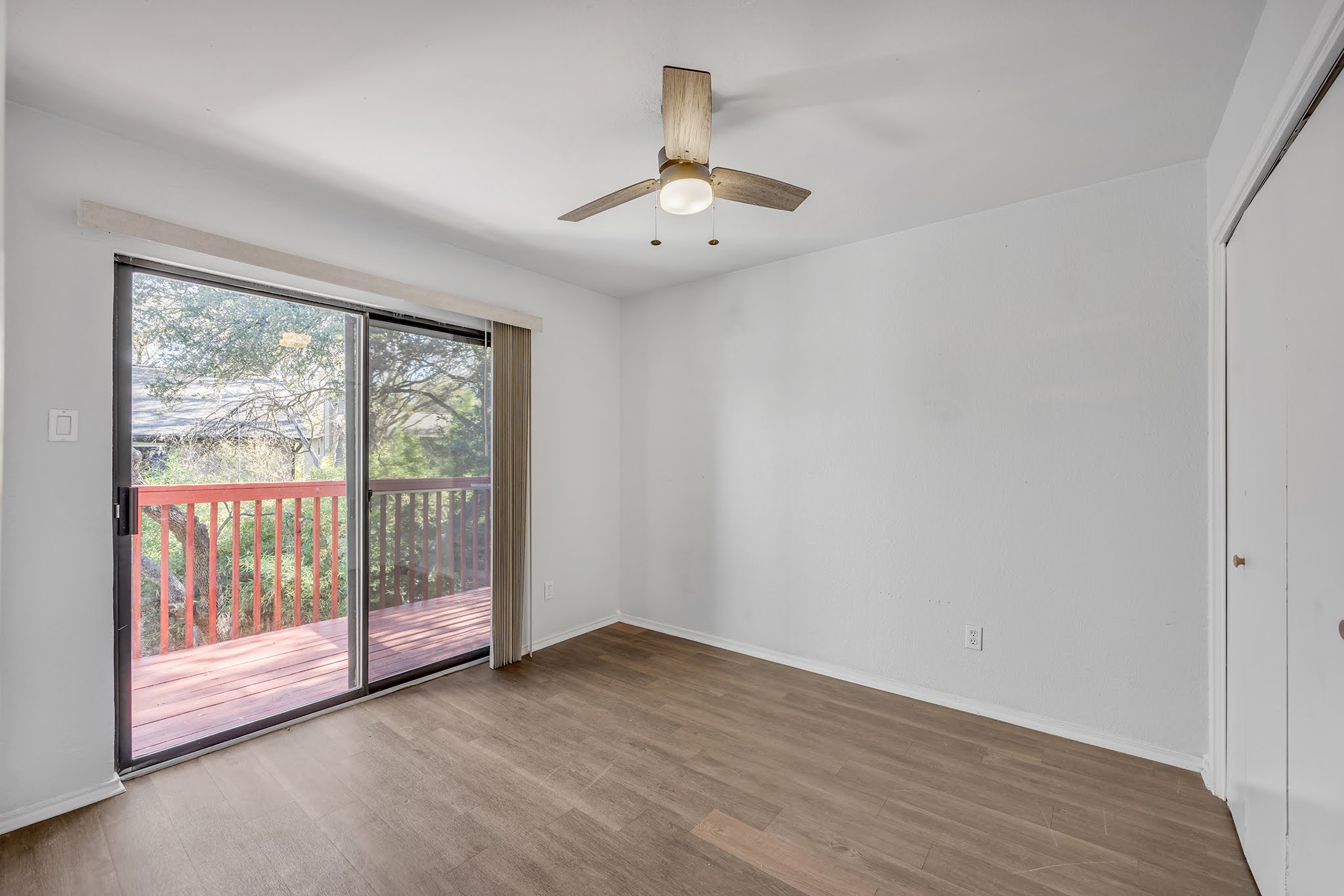 8102 Tuscarora Trail, Unit A Austin, TX 78729 - Photo 29 of 35 an empty room with wooden floor and windows
