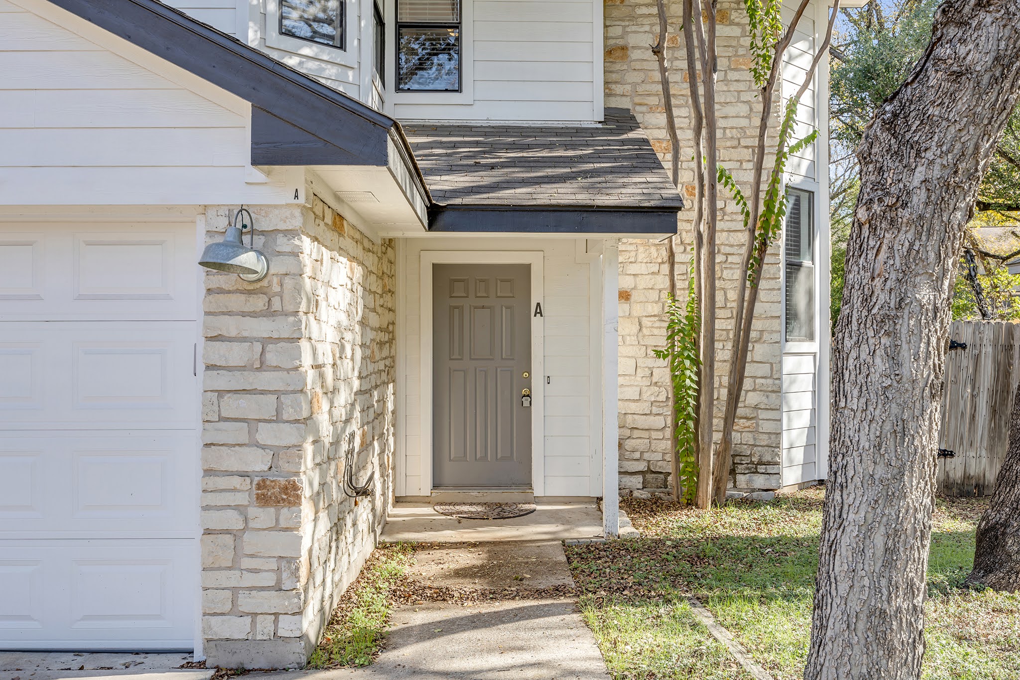 8102 Tuscarora Trail, Unit A Austin, TX 78729 - Photo 4 of 35 a front view of a house with a garden