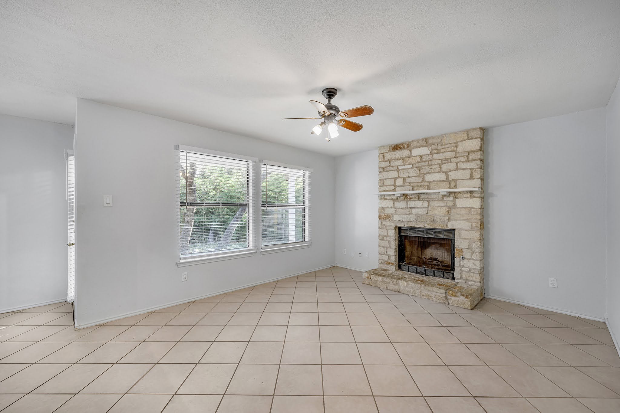 8102 Tuscarora Trail, Unit A Austin, TX 78729 - Photo 6 of 35 an empty room with windows and fireplace