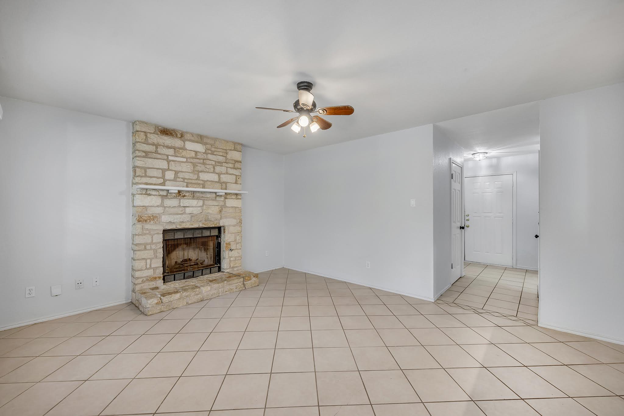 8102 Tuscarora Trail, Unit A Austin, TX 78729 - Photo 9 of 35 an empty room with windows and fireplace