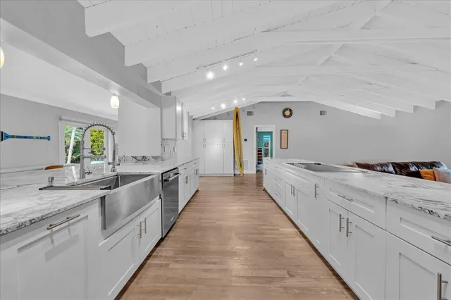 a large white kitchen with lots of counter space