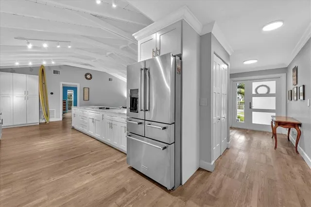 a kitchen with stainless steel appliances a refrigerator sink and cabinets
