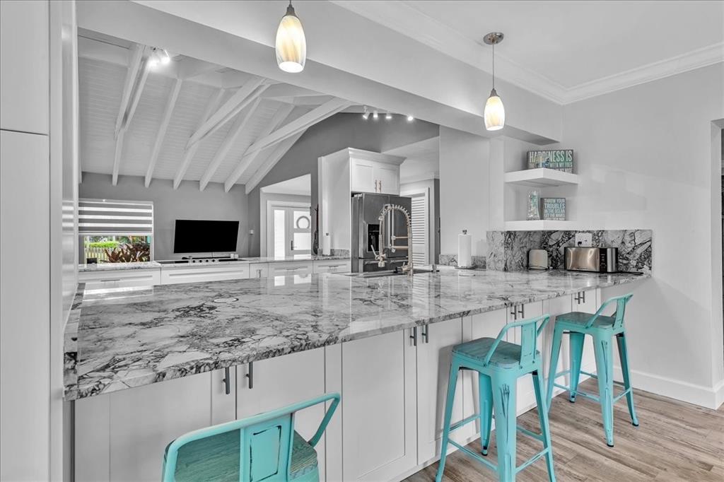 2931 Southwest 108th Way Davie, FL 33328 - Photo 17 of 36 a kitchen with stainless steel appliances granite countertop a sink a stove refrigerator and cabinets