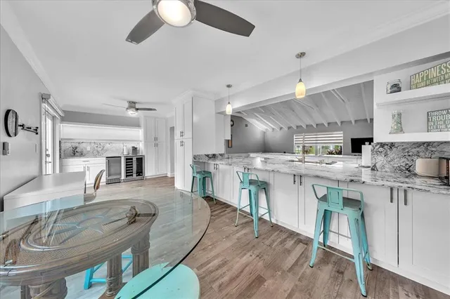 a large kitchen with lots of counter space a sink appliances and dining table