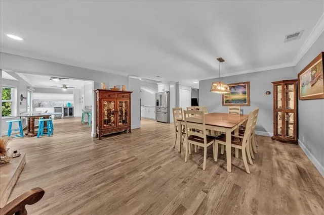 a dining room with furniture and wooden floor