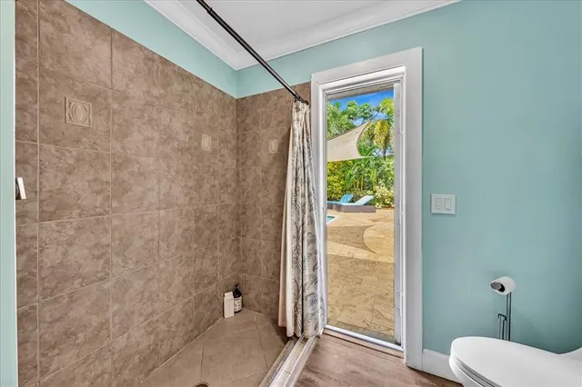 a bathroom with a granite countertop shower a toilet and a shower