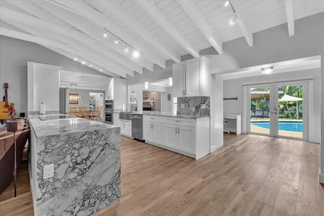 a view of kitchen with furniture and refrigerator