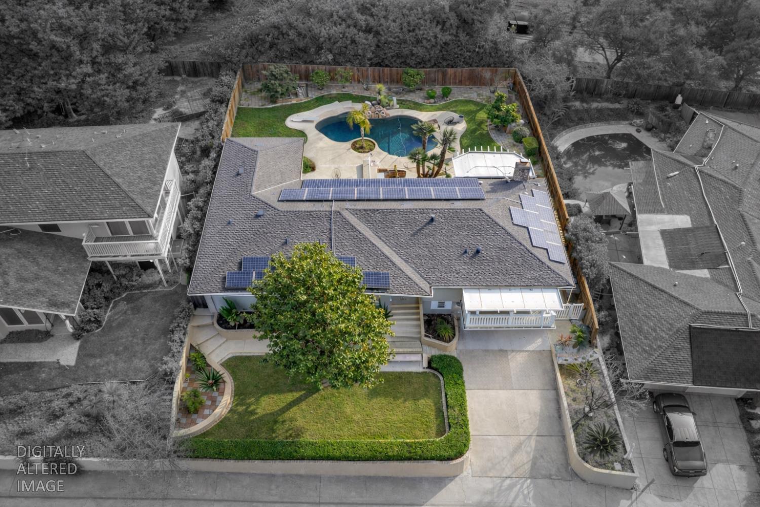 an aerial view of a house with garden space sitting space and swimming pool