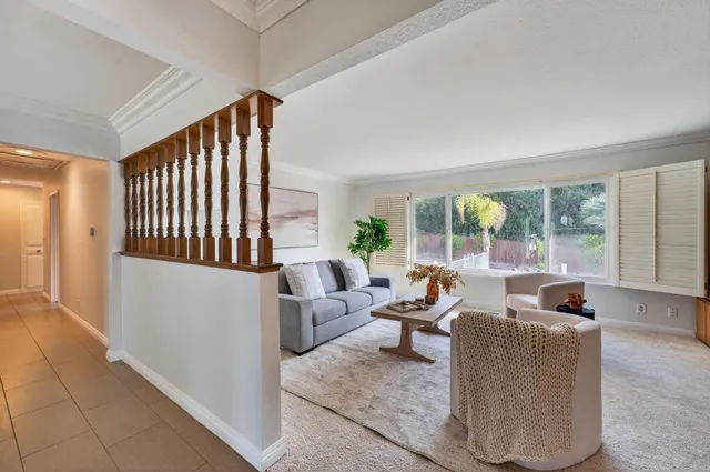 a kitchen with stainless steel appliances wooden cabinets dining table and chairs