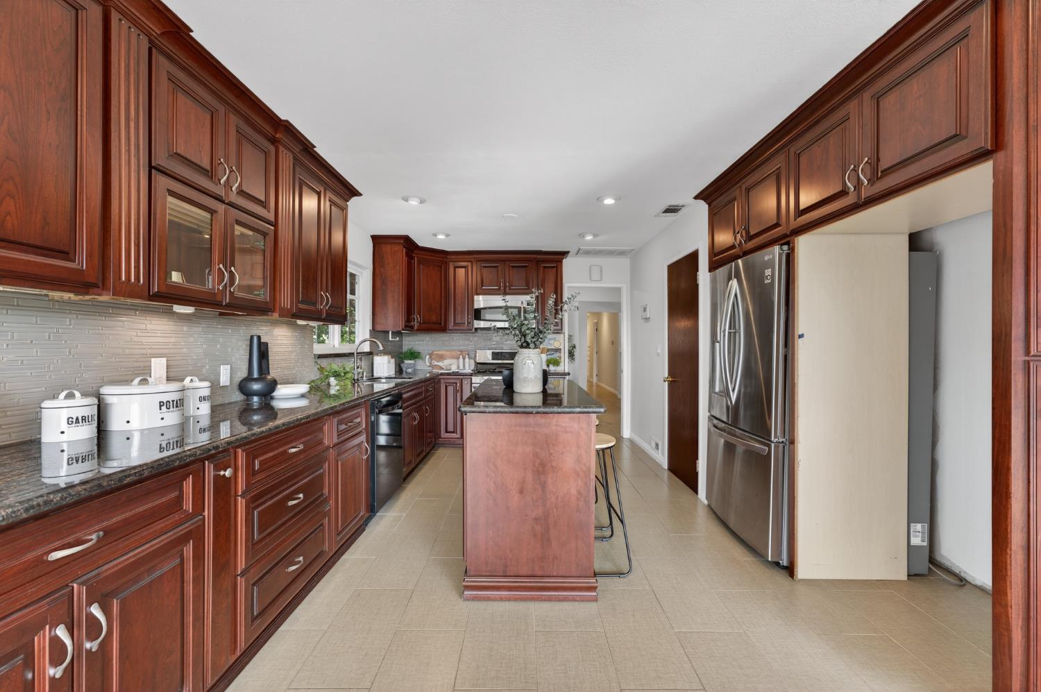 3006 Scenic Heights Way Carmichael, CA 95608 - Photo 20 of 76 a kitchen with stainless steel appliances granite countertop a refrigerator a stove top oven a sink and dishwasher