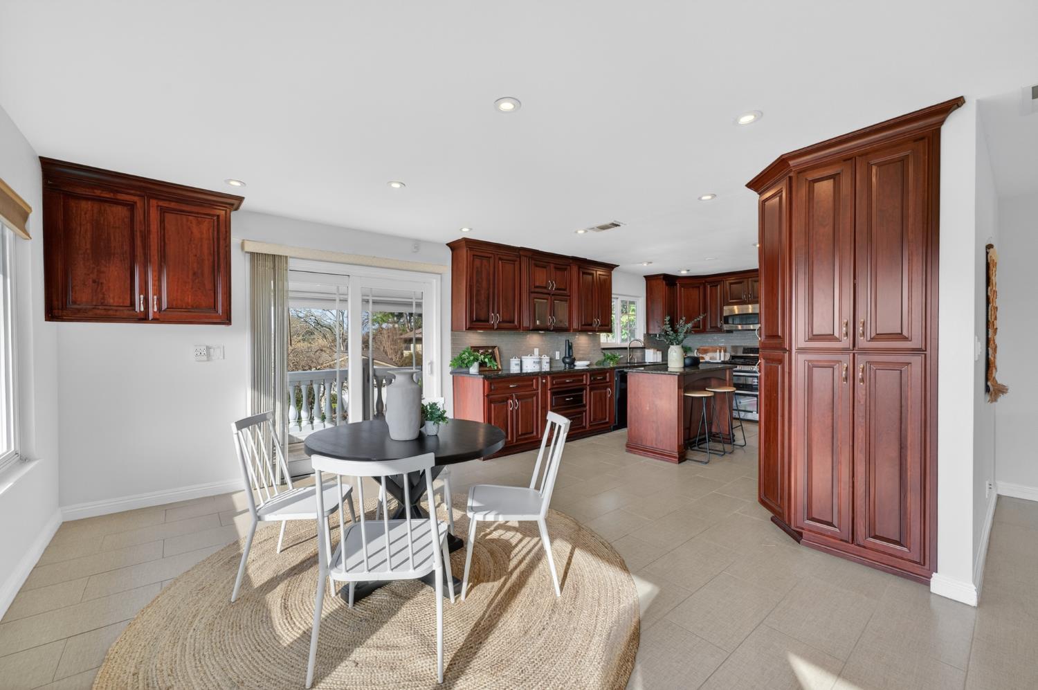 3006 Scenic Heights Way Carmichael, CA 95608 - Photo 23 of 76 a kitchen with stainless steel appliances wooden floor dining table and chairs