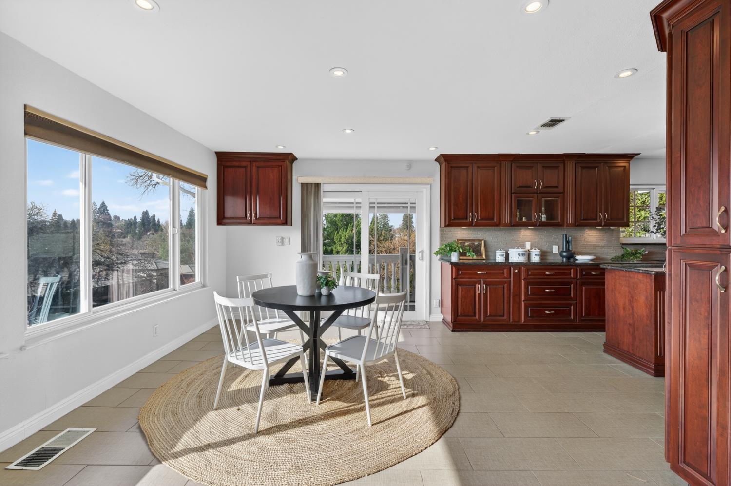 3006 Scenic Heights Way Carmichael, CA 95608 - Photo 24 of 76 a kitchen with stainless steel appliances wooden cabinets dining table and chairs