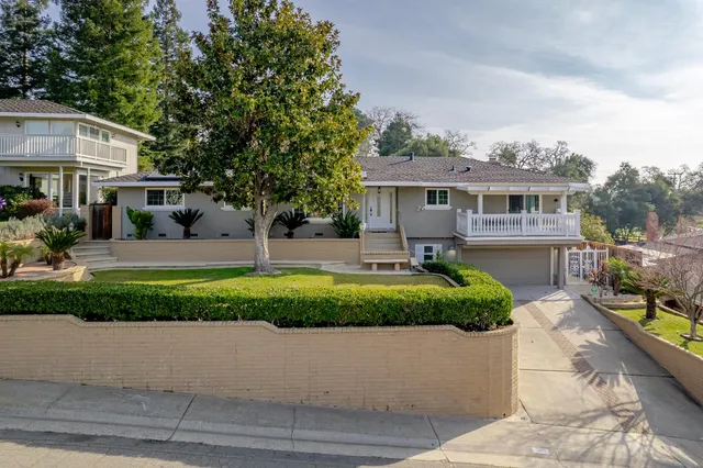 a front view of a house with a yard outdoor seating and porch