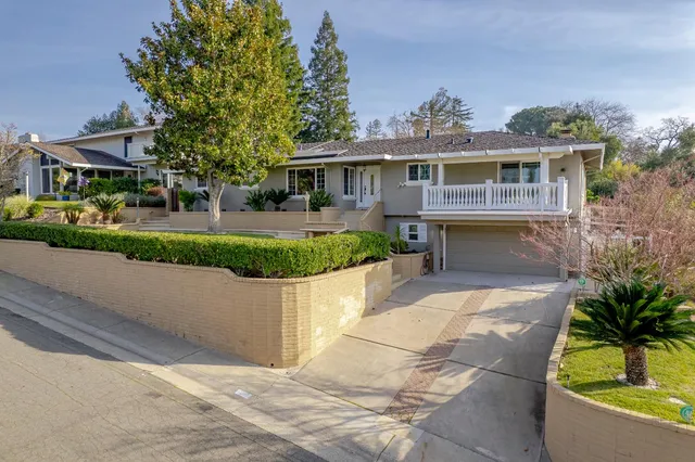 an aerial view of a house with a swimming pool and outdoor seating