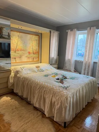 a bedroom with a bed and window