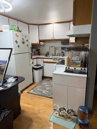 a kitchen with a refrigerator and a stove