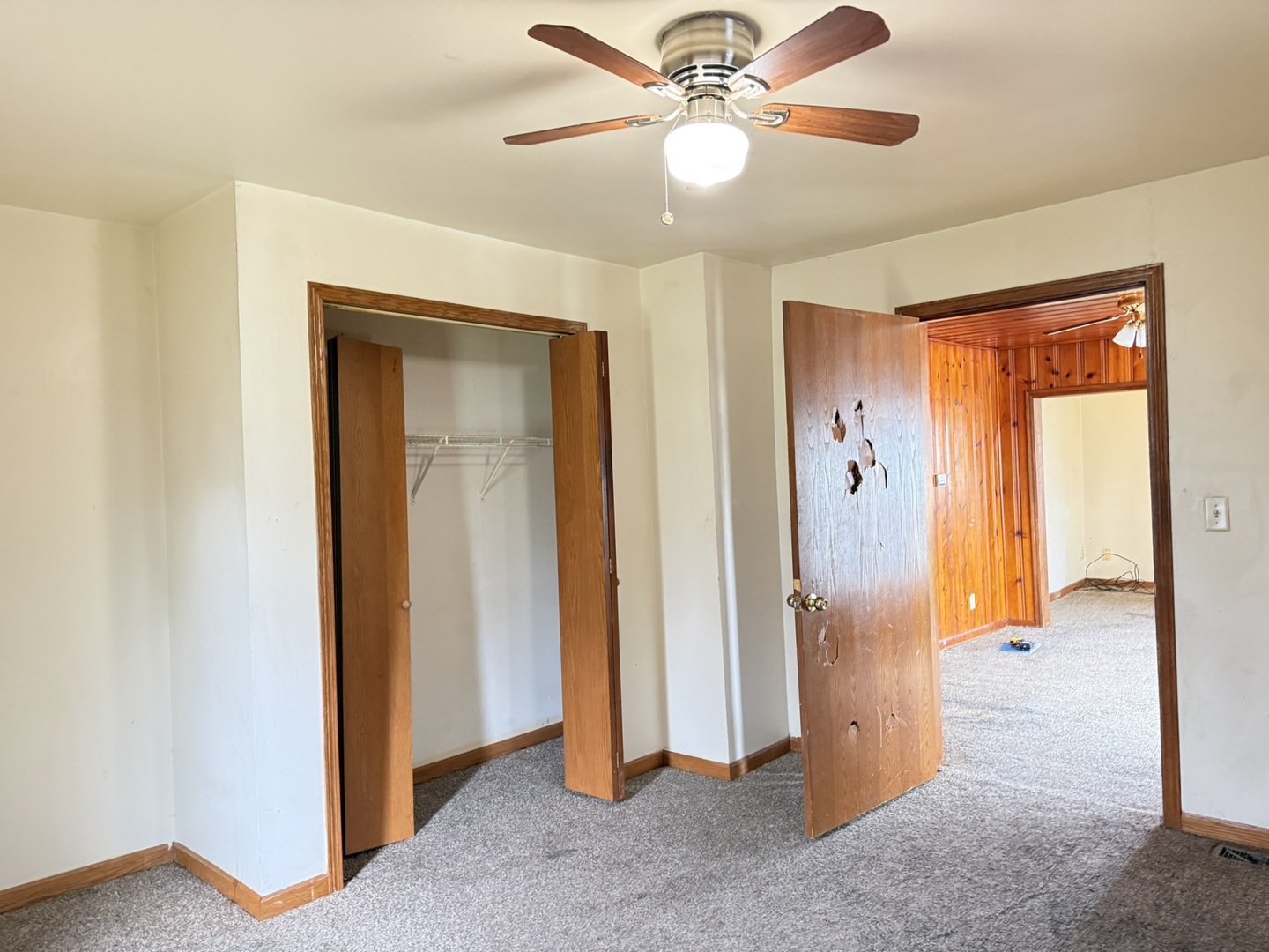 3245 9th Street Rockford, IL 61109 - Photo 21 of 26 a view of a livingroom with a chandelier fan and a hallway