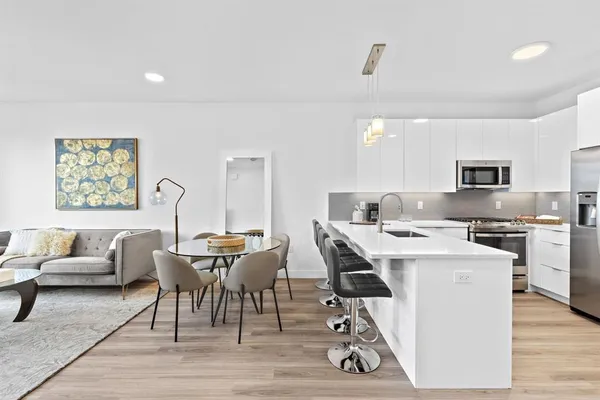 a view of a dining room with furniture and a kitchen