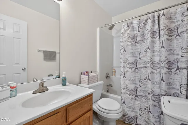 a bedroom with a bed and a refrigerator