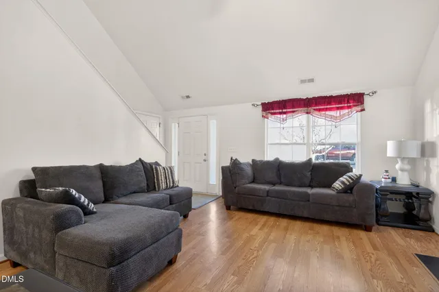 a living room with furniture a window and a fireplace