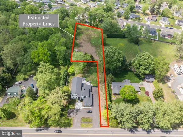 an aerial view of a house with a yard and lake view